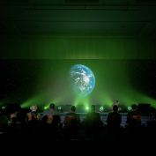 Image of a crowd with a projection of the Earth. Included in a blog post about COP28.